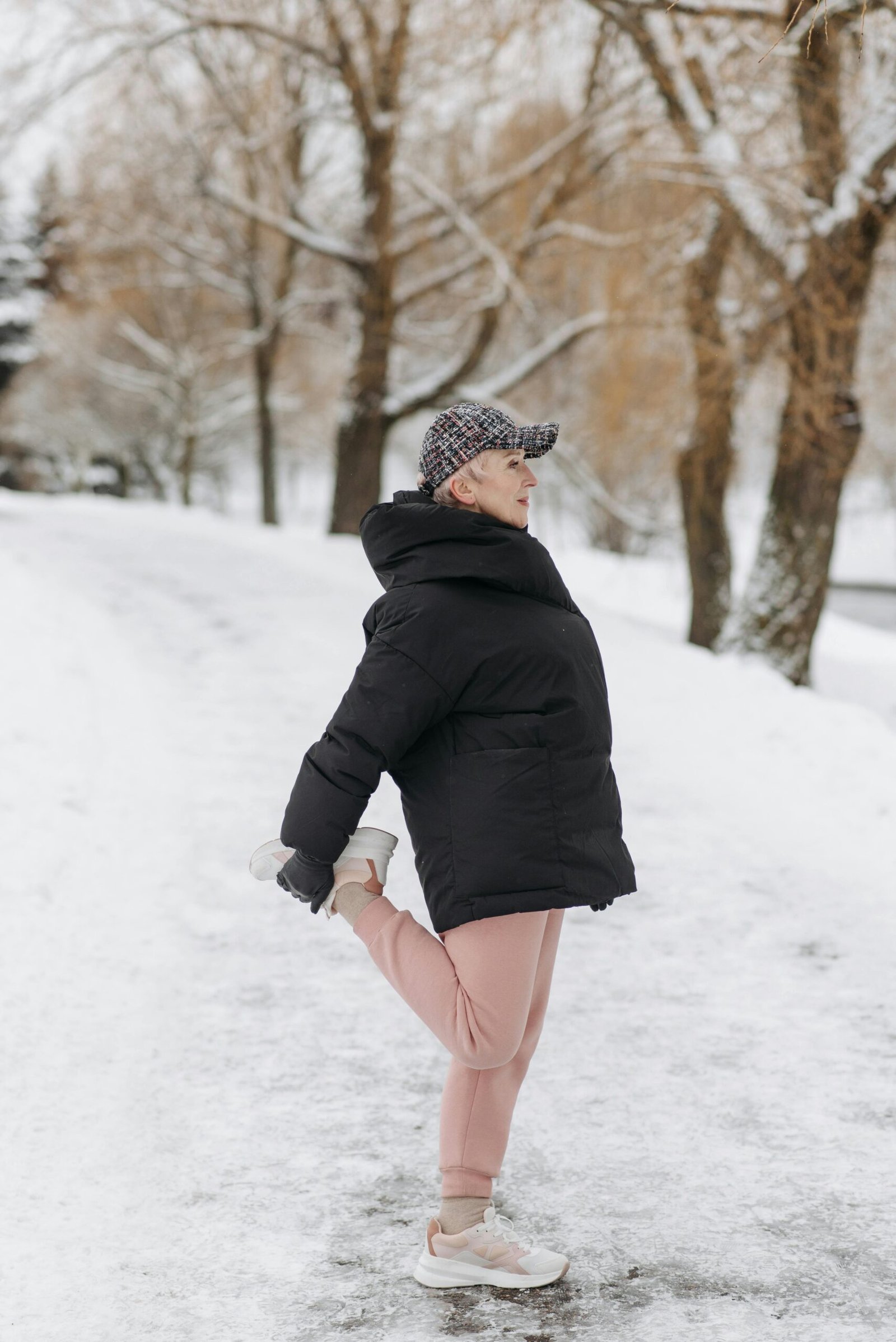 senior-woman-stretching-winter-snow